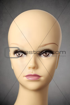 Mannequin head on dark grey background