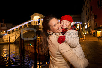 Smiling mother and daughter near Rialto Bridge Christmas Venice