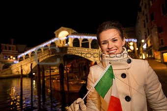 Tourist woman with Italian flag spending Christmas in Venice