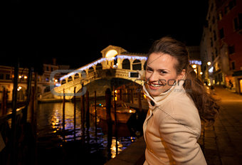 Woman taking photo of Rialto Bridge in Christmas Venice, Italy