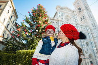 Mother and daughter standing near Christmas tree in Florence