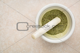 stevia leaves crushed in mortar 