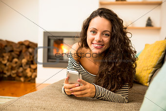 Woman with her cellphone at home