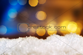 snow with lights in background