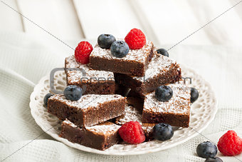 Chocolate brownies decorated with fresh berries