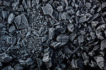 Black coal in white frost.