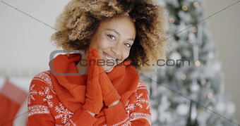 Smiling happy young woman in a Christmas outfit