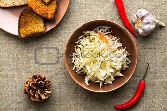 Top view of pickled cabbage on linen fabric background
