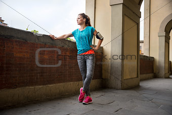 Young fitness woman is getting ready for outdoors jogging