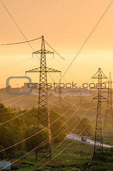 Power lines illuminated by the setting sun