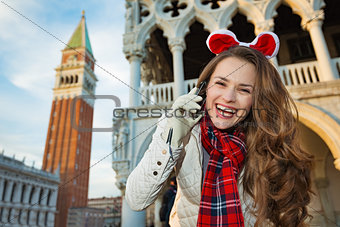 Woman tourist talking mobile while on Christmas in Venice, Italy
