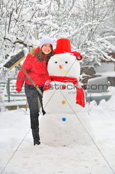 happy girl making a snowman