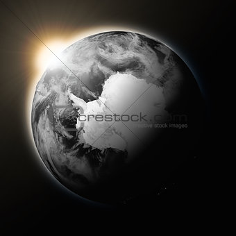 Sun over Antarctica on dark planet Earth