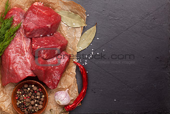 Raw fillet beef steak and spices on stone board