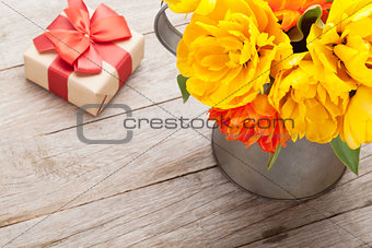 Colorful tulips bouquet and gift box