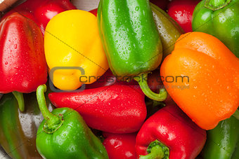 Fresh colorful bell peppers on wooden table