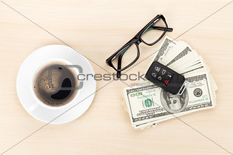 Money cash, glasses, car remote and coffee cup
