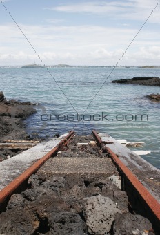 Train track into the ocean