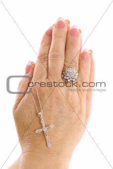 shot of praying hands with cross