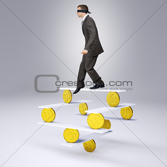 Worker with band on his eyes standing onto balance