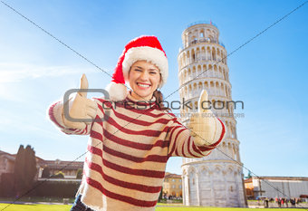 Woman in Santa hat showing thumbs up near Leaning Tour of Pisa