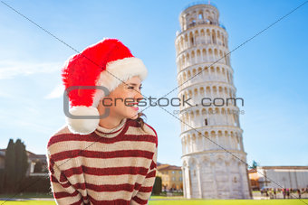 Woman in Santa hat looking on something near Leaning Tour, Pisa