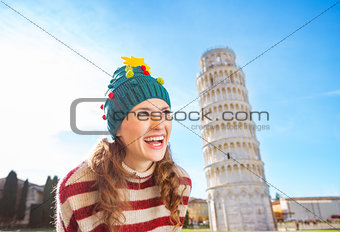 Happy woman in Christmas tree hat near Leaning Tour of Pisa