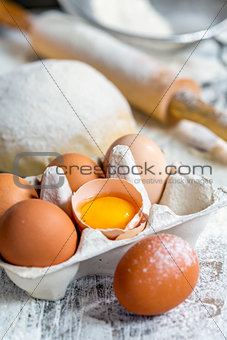 Tray with eggs, dough and rolling pin.