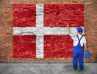 House painter paints flag of Denmark 