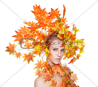 Beautiful woman wrapped in autumn leafs
