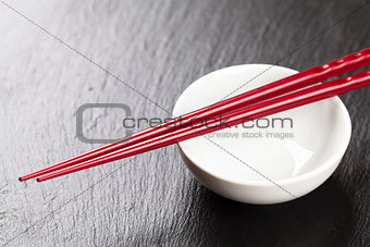 Japanese sushi chopsticks over soy sauce bowl