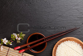 Japanese sushi chopsticks, soy sauce bowl, rice and sakura bloss