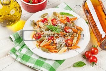 Colorful penne pasta and white wine