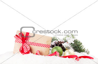 Christmas gift box and decor in snow