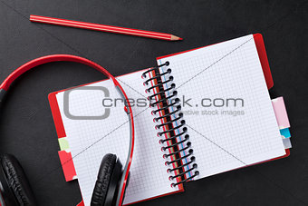 Desk with notepad and headphones