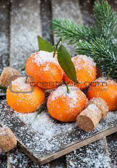Fresh tangerine on the snow-covered table