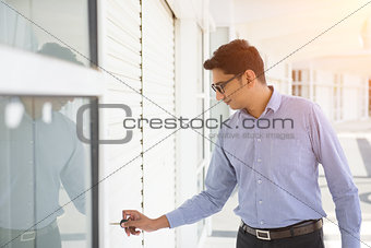 indian business male checking properties