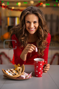 Woman having a cup of hot chocolate and Christmas sweets