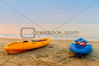 two kayaks on the beach early in the morning