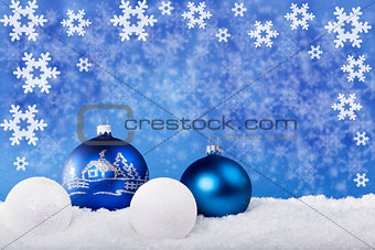 Blue Christmas balls in the snow