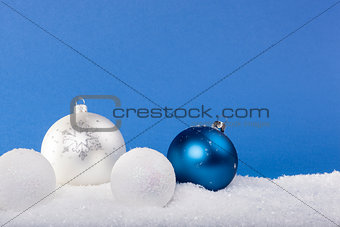 Blue Christmas balls in the snow