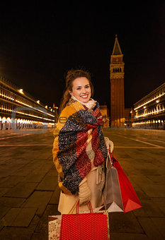 Woman in winter coat with shopping bags on Piazza San Marco