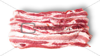 Several pieces of bacon stacked in layers