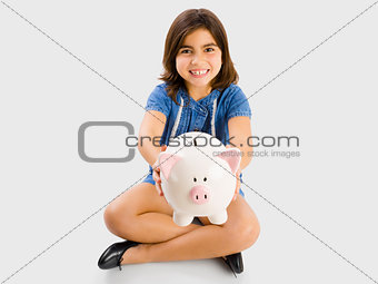 Young girl holding a piggybank