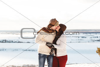 Beautiful girl and boy with husky dog in winter forest