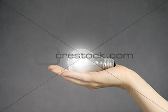 Hand with light bulb and copyspace