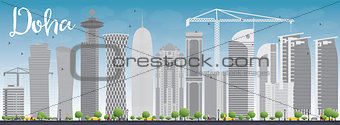 Doha skyline with grey skyscrapers and blue sky