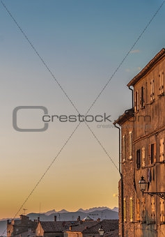Sunset light over old buildings in Volterra