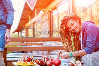 young couple in the garden eating pomegranates