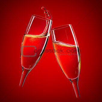 Two champagne glasses over red